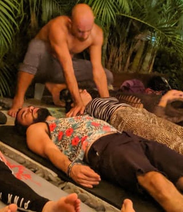 Thai bodywork session with people lying on mats